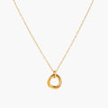 Delicate gold-plated necklace with three interlocking circle rings forming a minimalist knot pendant on cream background