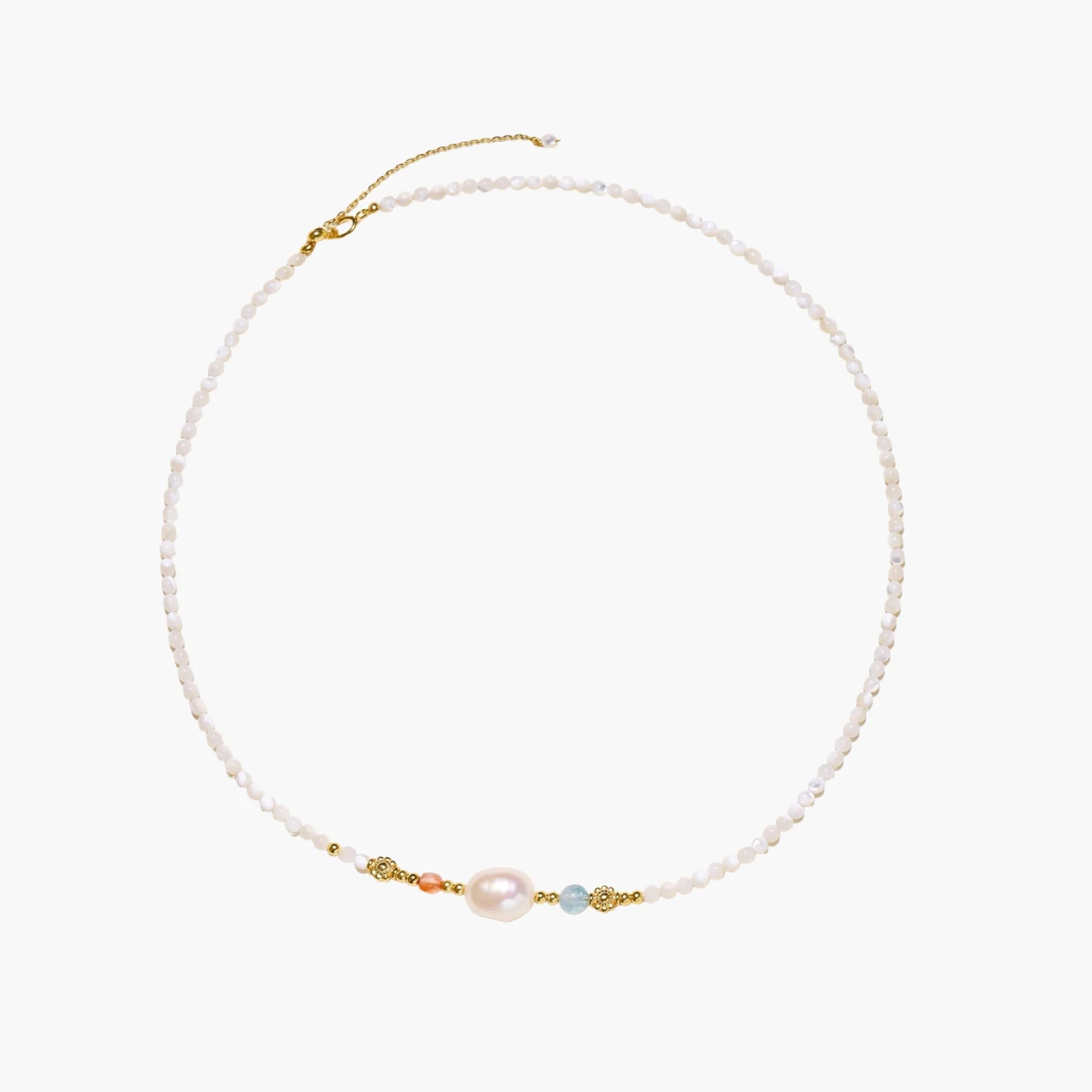 Delicate white beaded necklace with baroque pearl center, gold accents, and coral and aqua gemstones on cream background.