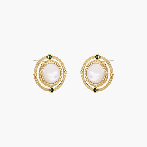 Circular gold stud earrings with iridescent mother-of-pearl center and green zirconia accents on cream background.