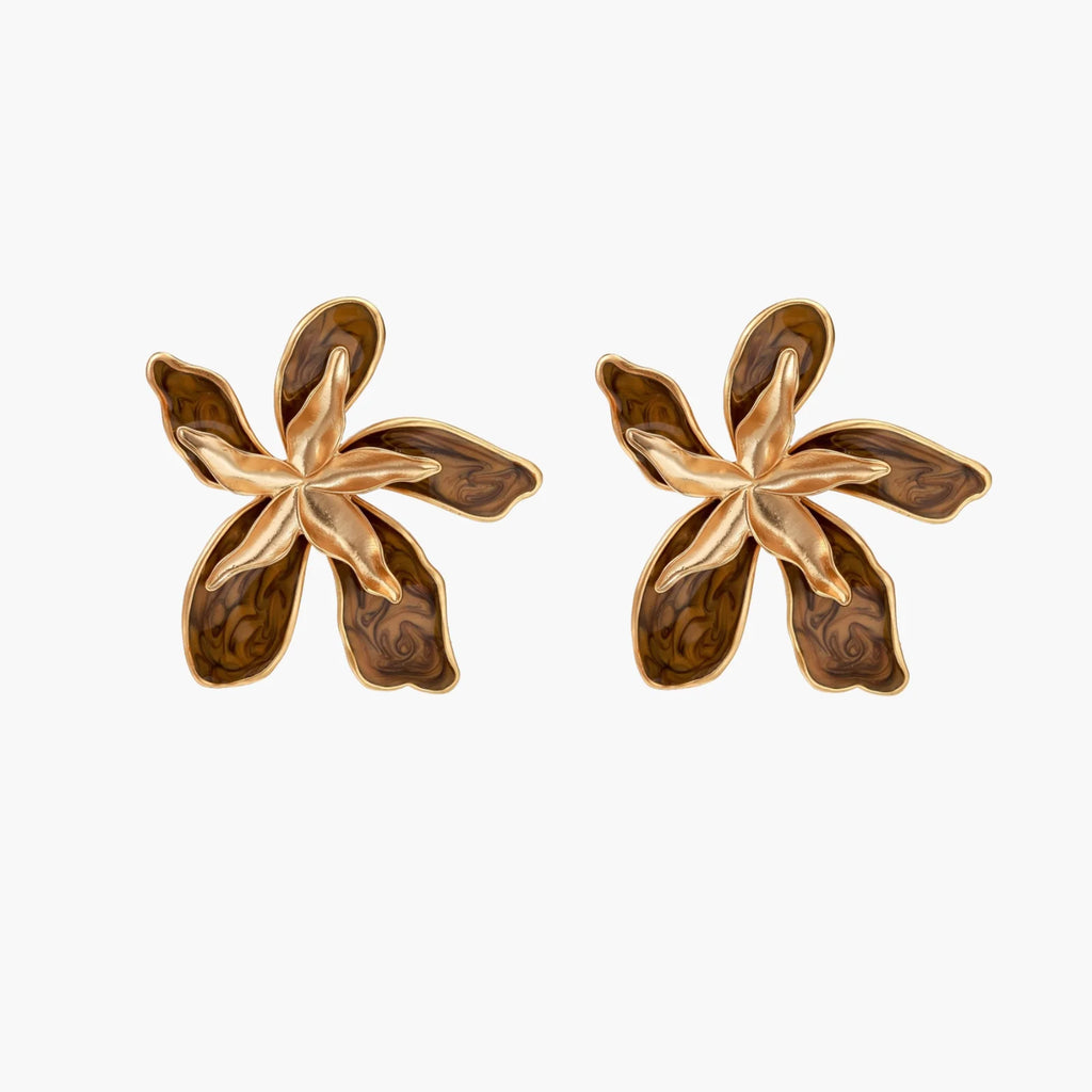 Gold-plated brass flower earrings with brown tortoiseshell enamel petals on cream background