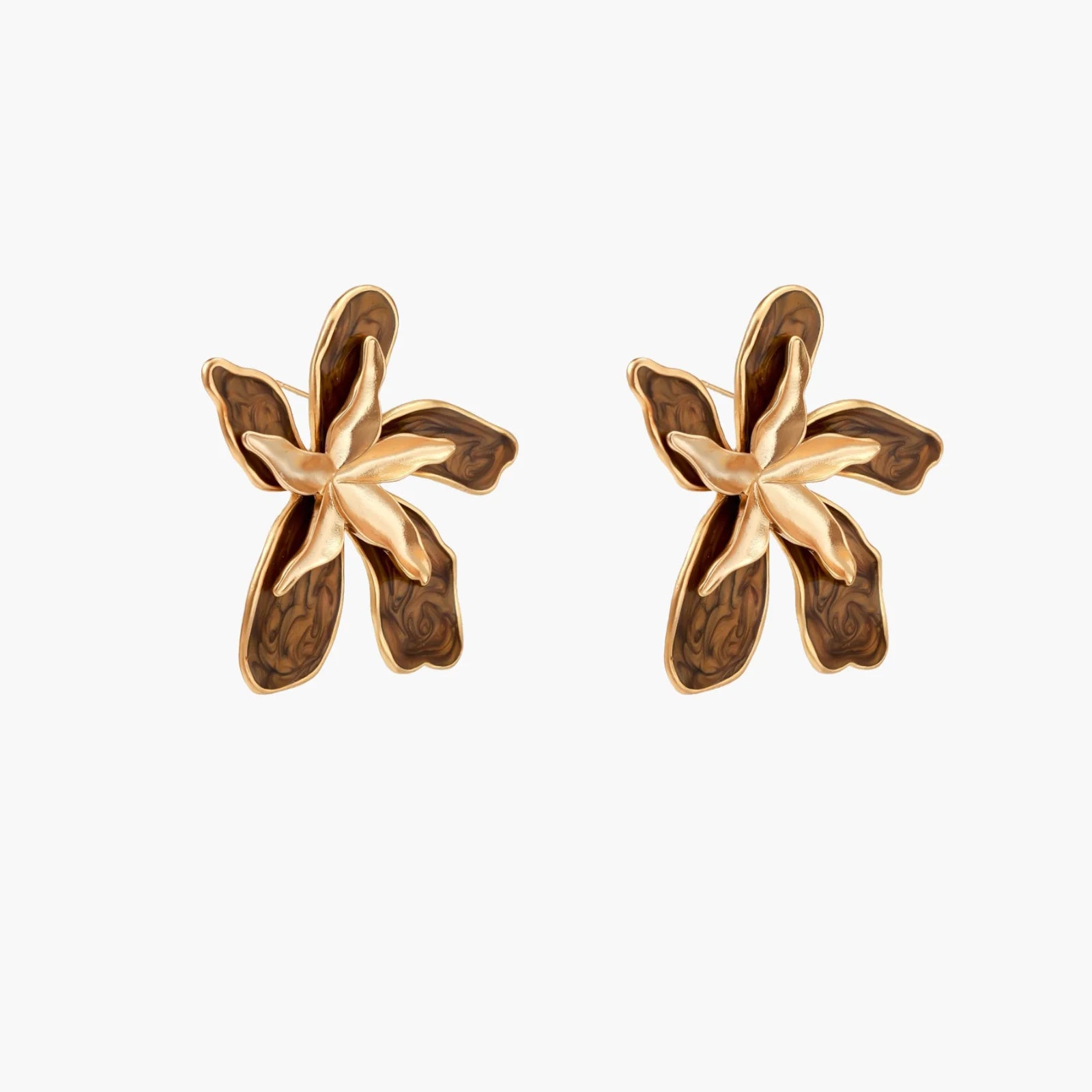 Gold-plated brass flower earrings with brown tortoiseshell enamel petals on cream background