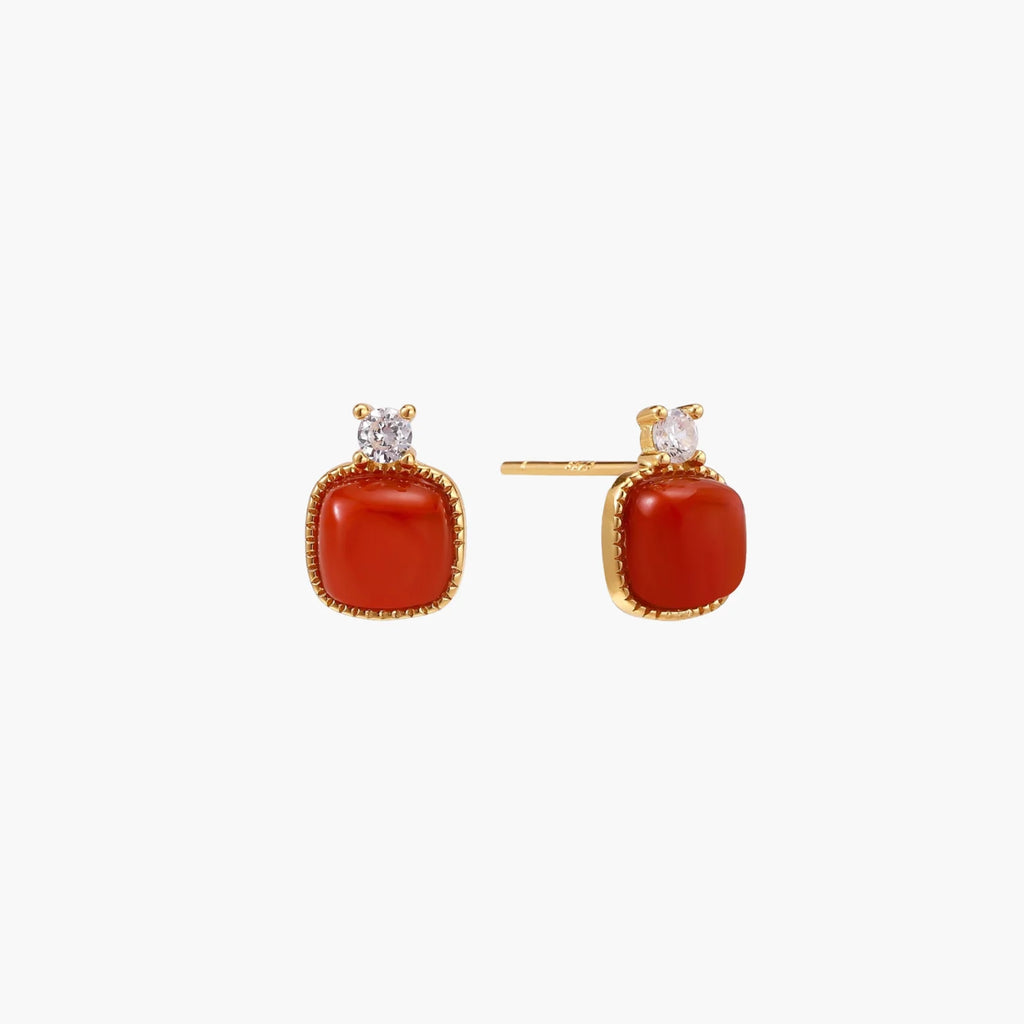 18K gold vermeil stud earrings with cushion-cut red agate stones and sparkling crystal accents on beige background