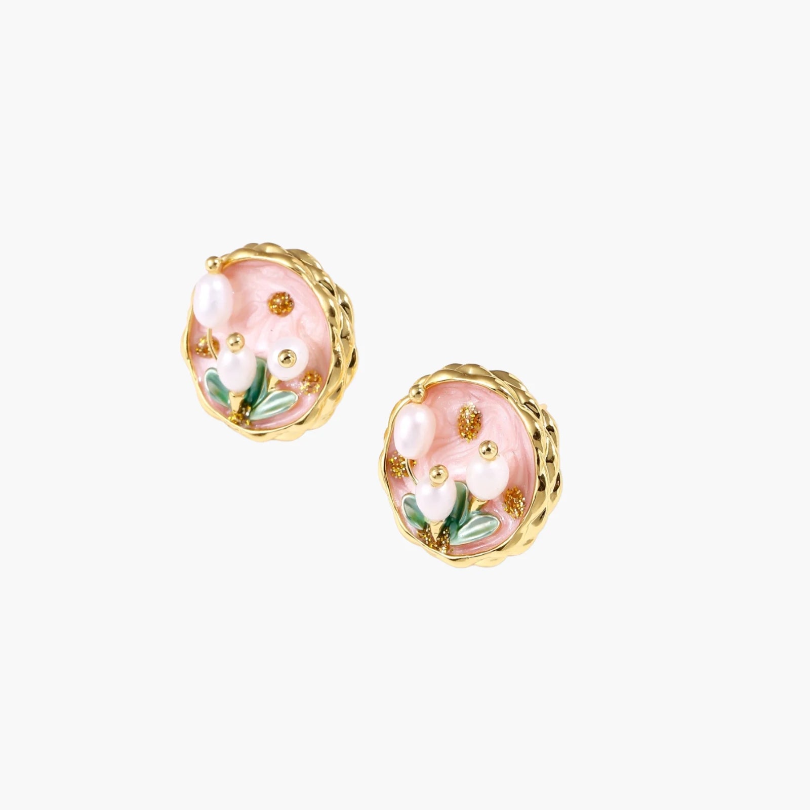 Round stud earrings with pink enamel, three white freshwater pearls, green leaves, and gold-plated braided border