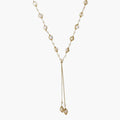 Adjustable gold lariat necklace with freshwater pearls nested in delicate cage settings and Y-shaped tassel drop