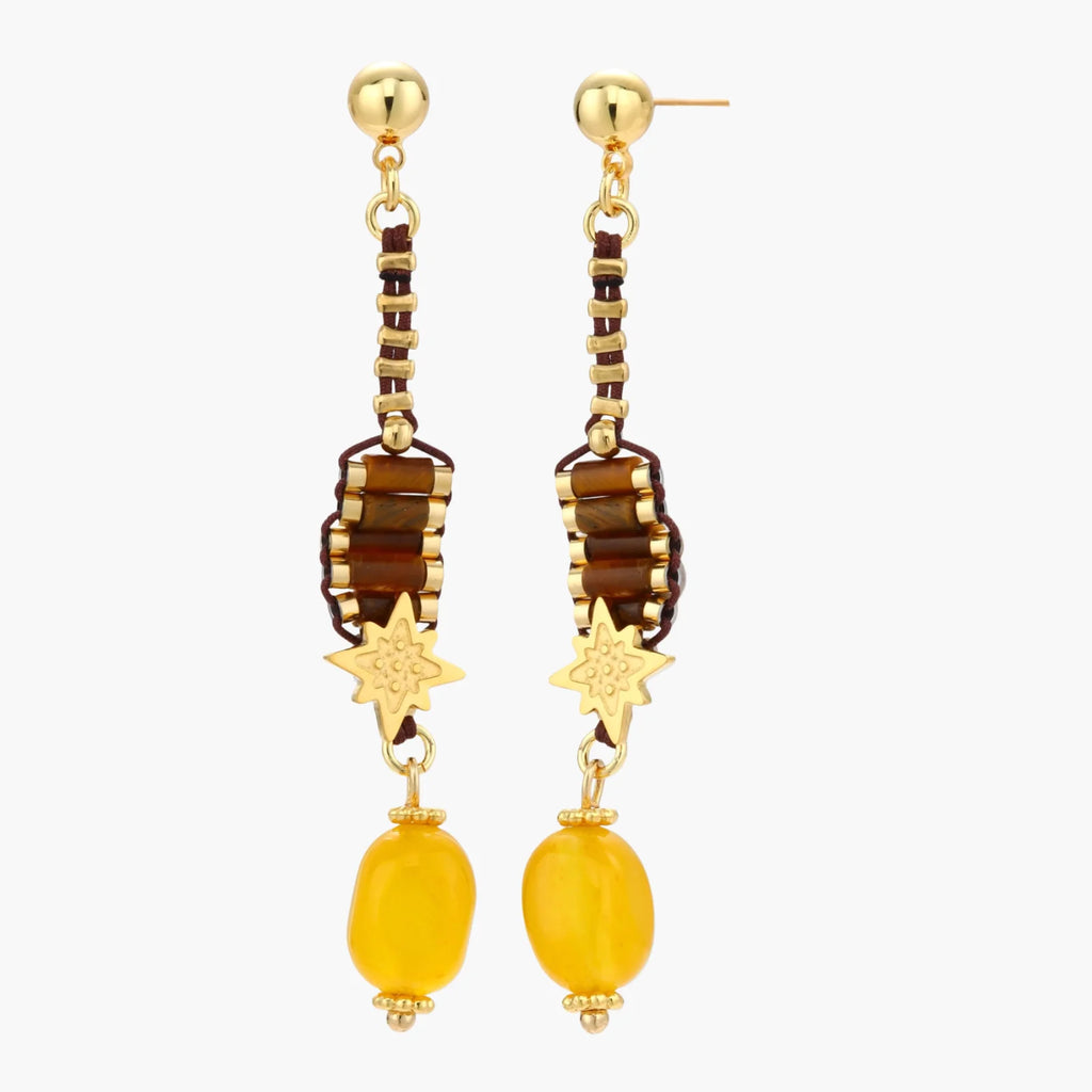Gold-plated dangle earrings with brown gemstones, star charms, and yellow amber drops on cream background.