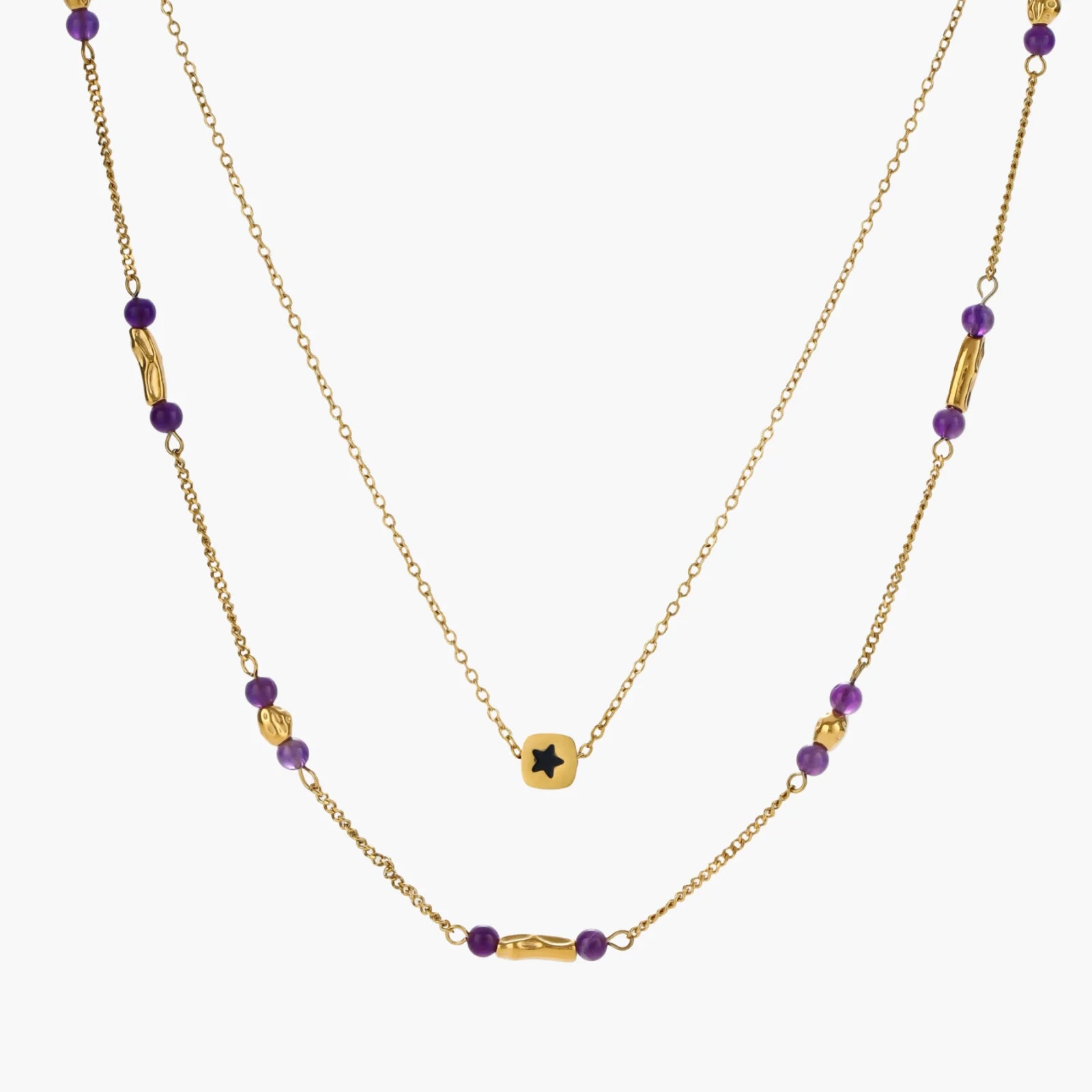 Two layered gold-tone necklaces with purple stone beads and star pendant against cream background.