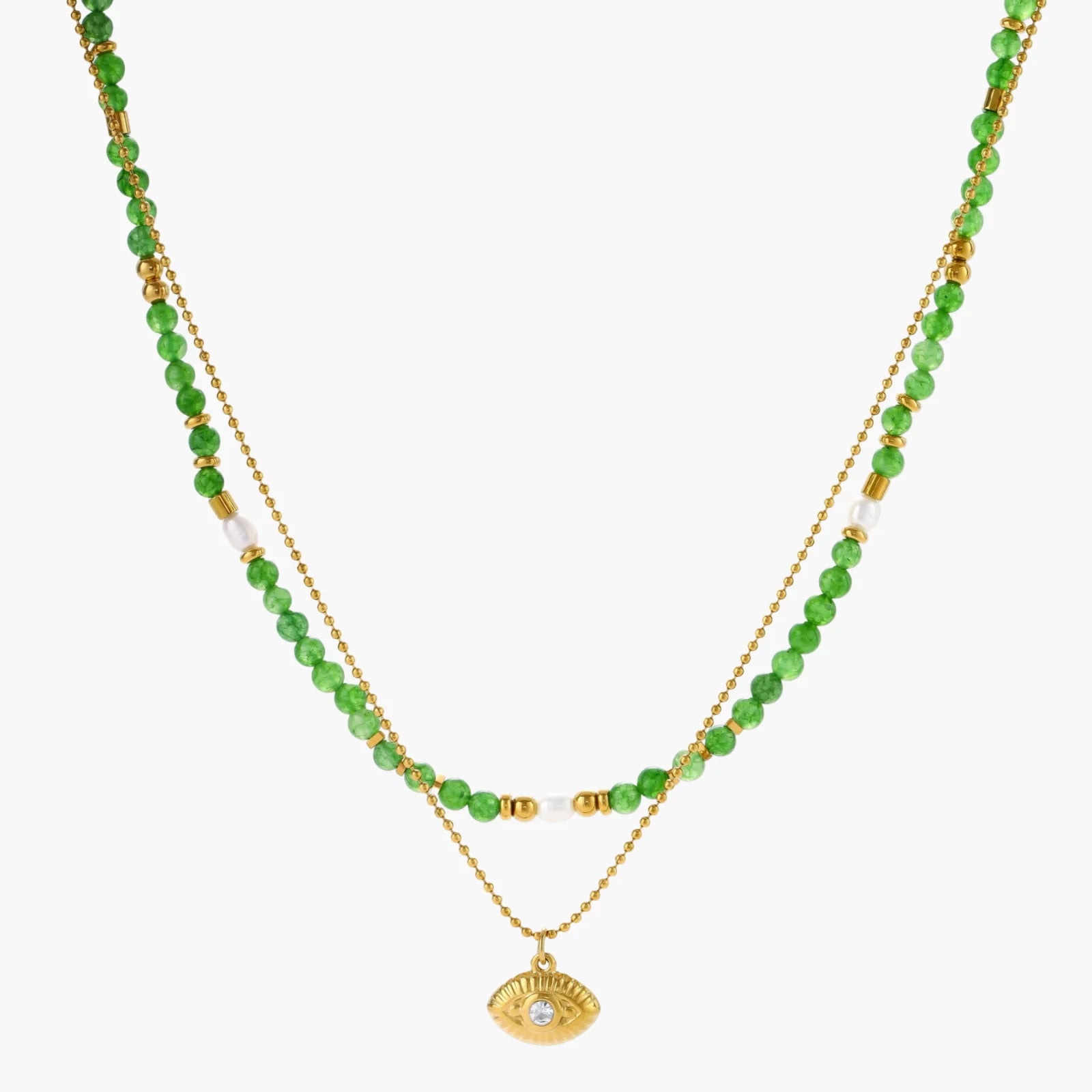 Layered necklace with green stone beads, gold spacers, white accents, and protective eye pendant on cream background.