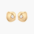 Organic-shaped eco-zinc alloy stud earrings with resin pearl centers and sterling silver posts on white background.