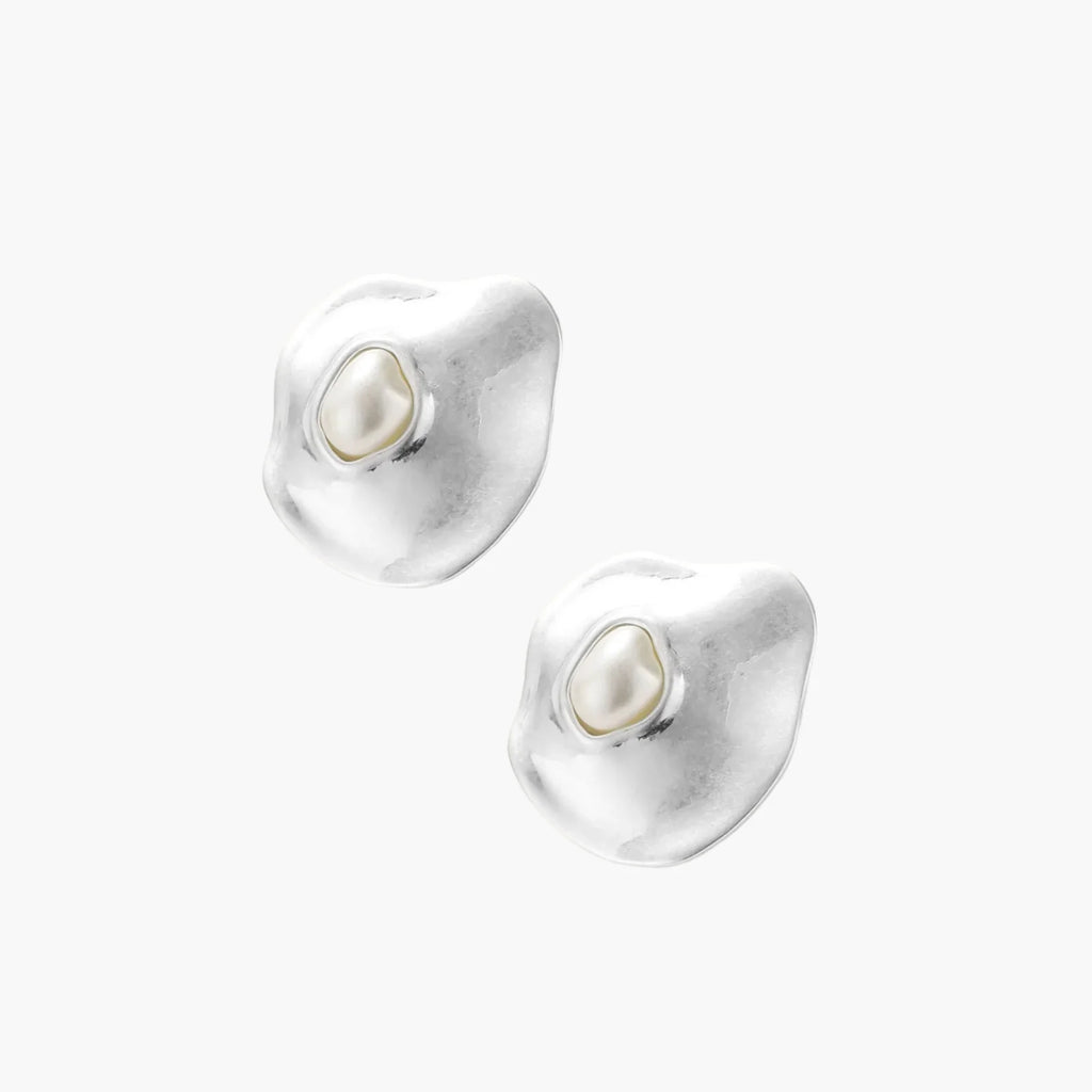 Organic-shaped eco-zinc alloy stud earrings with resin pearl centers and sterling silver posts on white background.