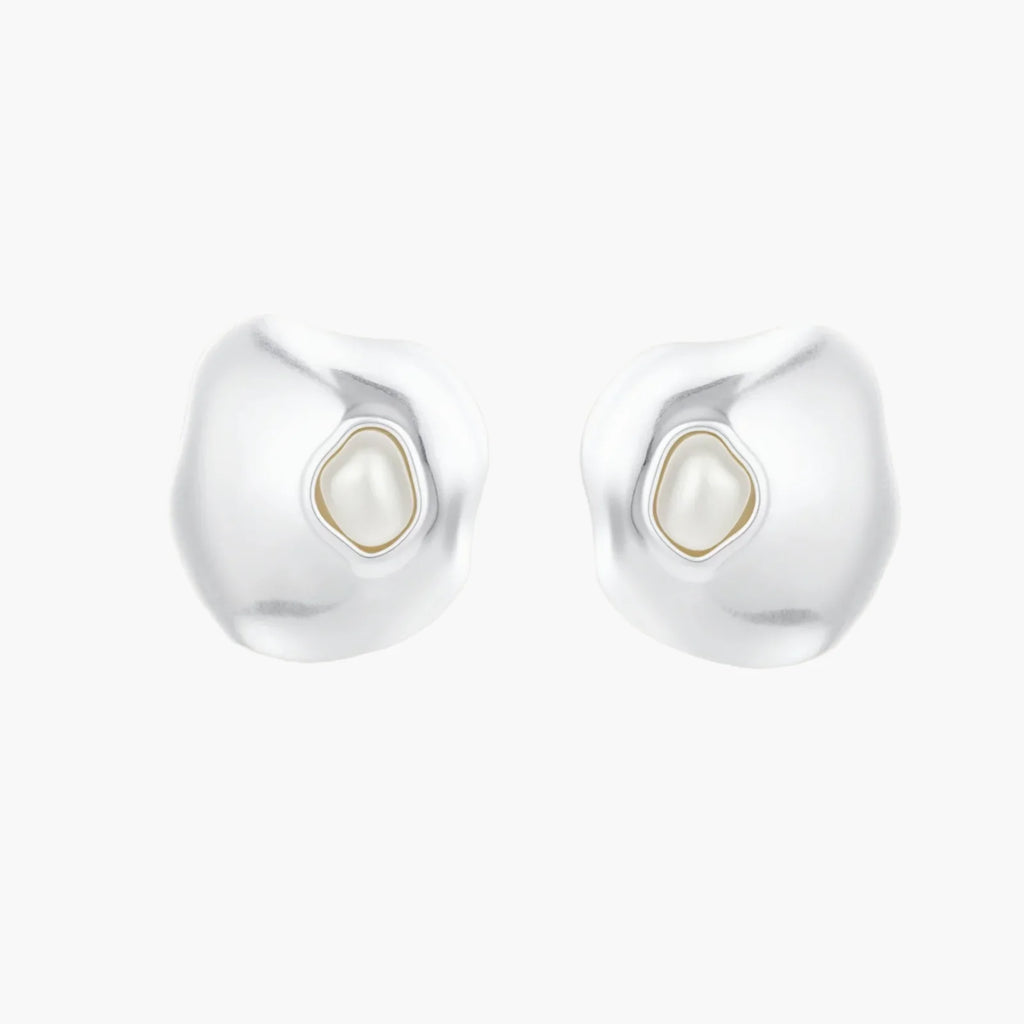 Organic-shaped eco-zinc alloy stud earrings with resin pearl centers and sterling silver posts on white background.