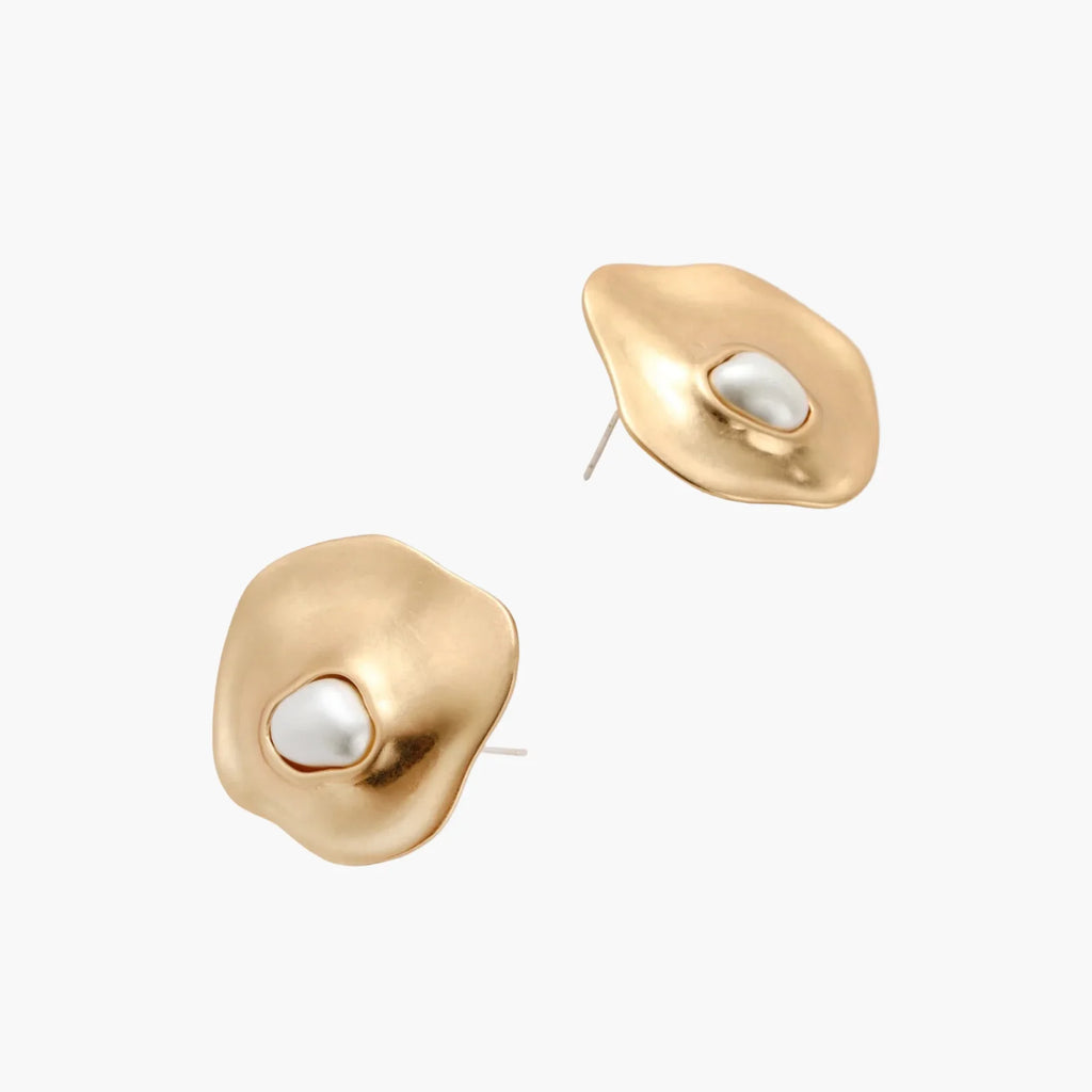 Organic-shaped eco-zinc alloy stud earrings with resin pearl centers and sterling silver posts on white background.