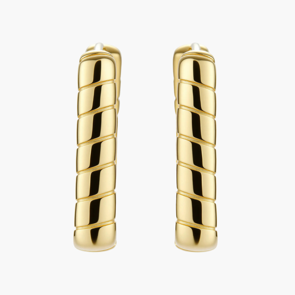 Chunky segmented gold-plated huggie hoop earrings with bamboo-inspired geometric design on white background.