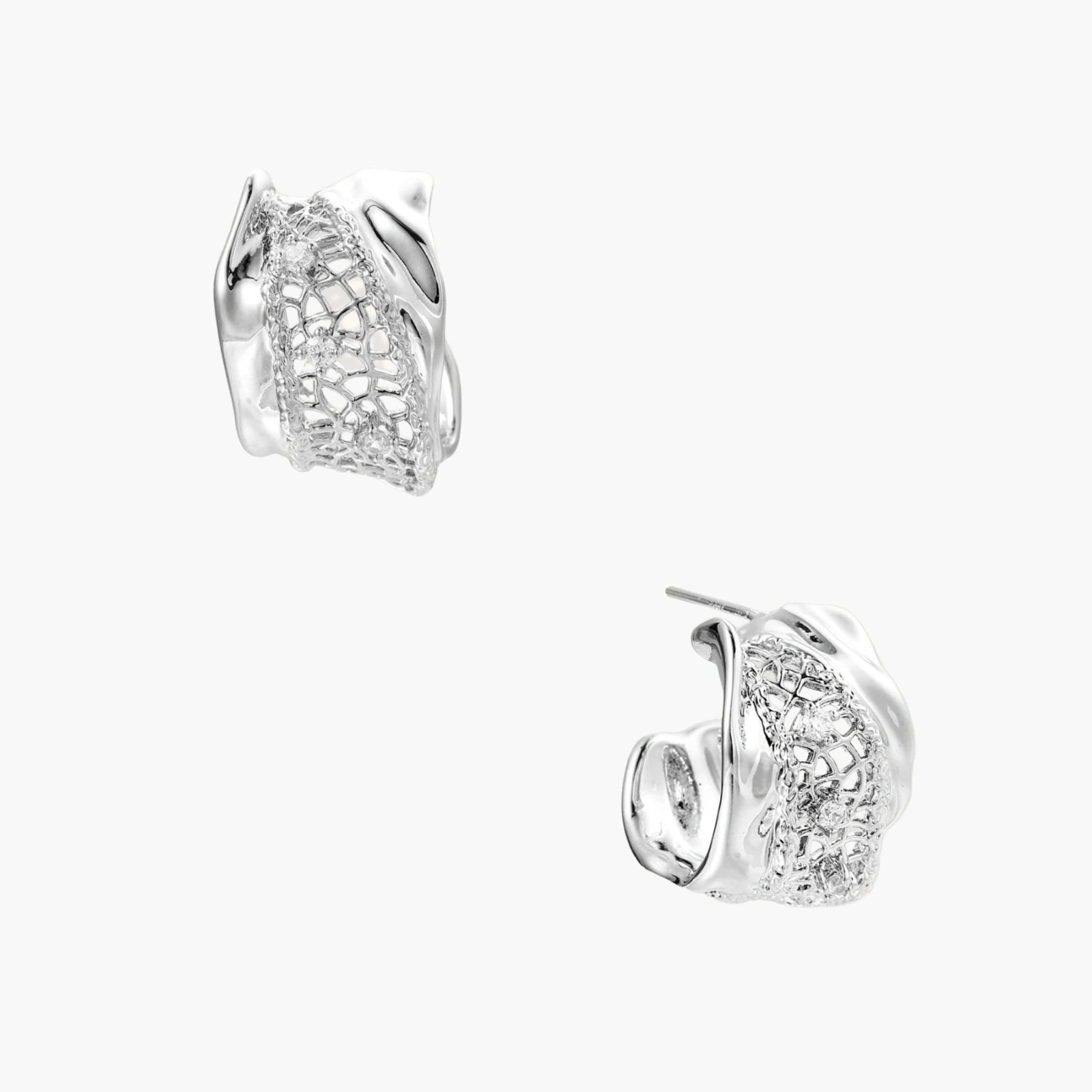 Close-up of sculptural hoop earrings with lattice center band and smooth twisted edges in white gold-plated brass with zirconia
