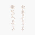Long sterling silver drop earrings with delicate floral vine design and crystal accents on white background