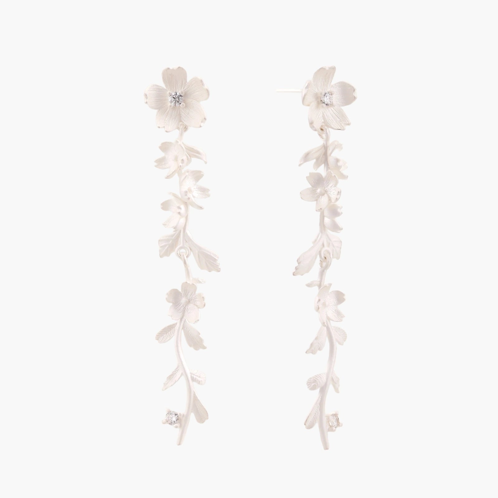 Long sterling silver drop earrings with delicate floral vine design and crystal accents on white background