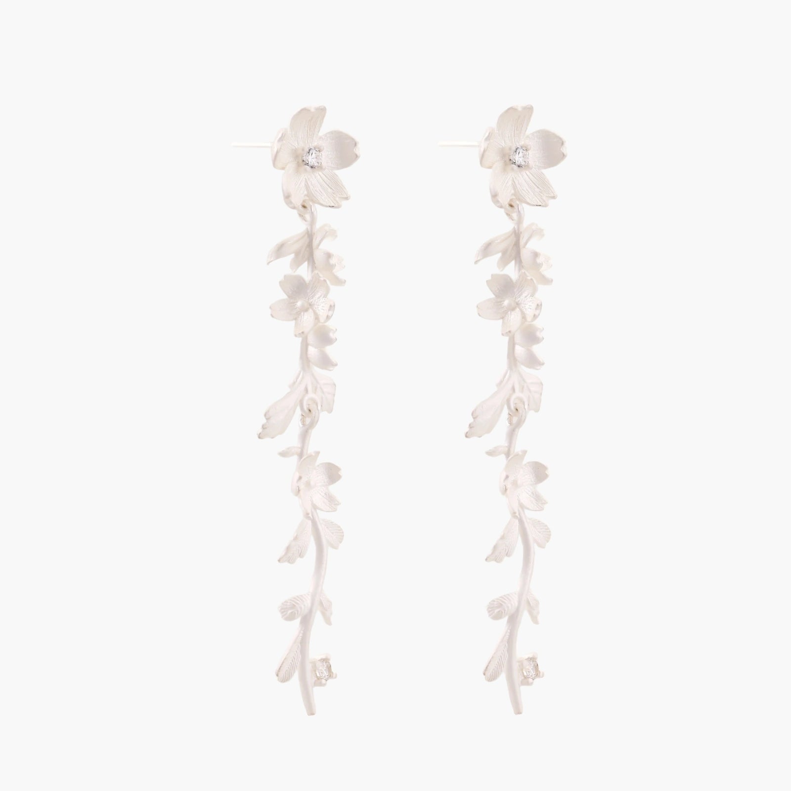 Long sterling silver drop earrings with delicate floral vine design and crystal accents on white background