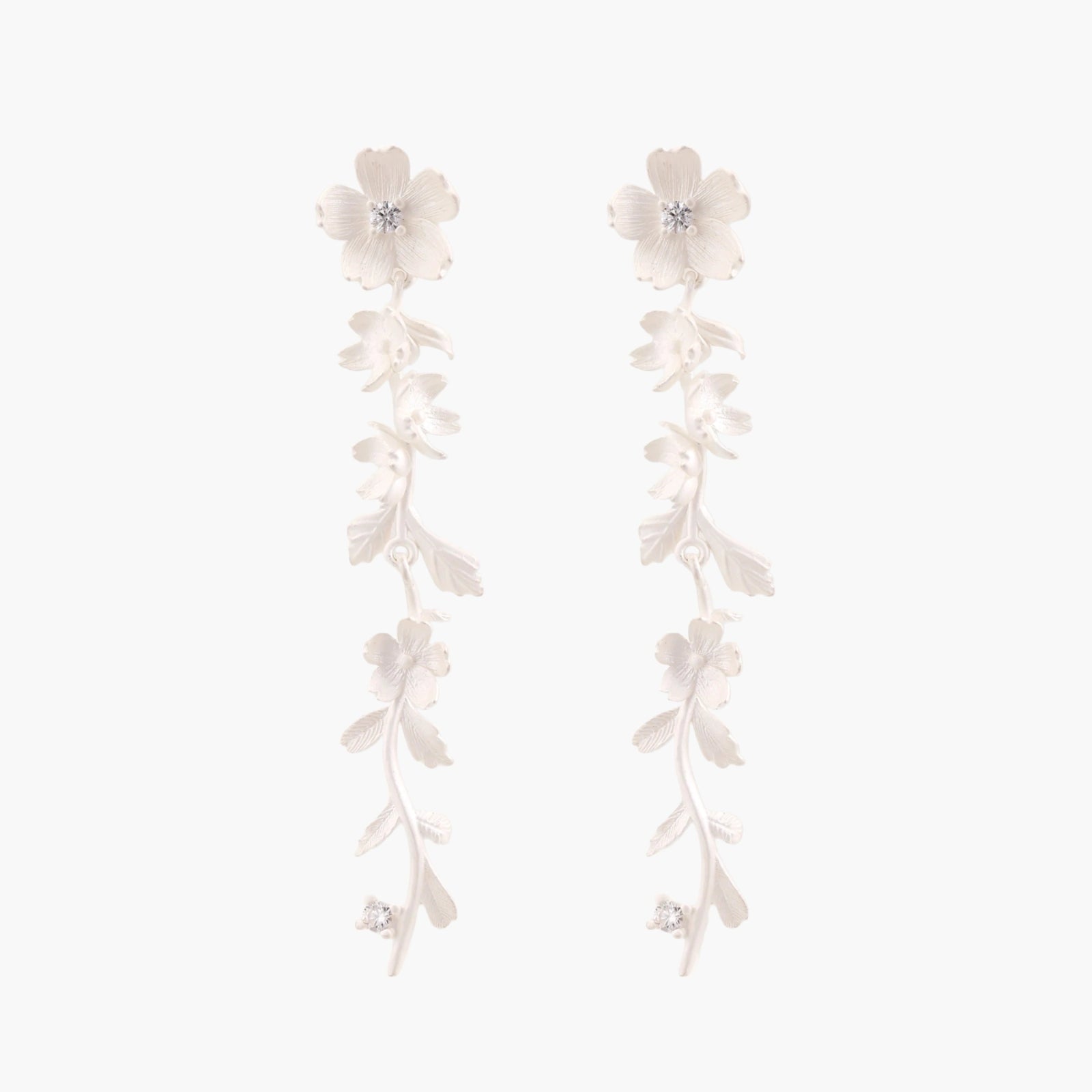 Long sterling silver drop earrings with delicate floral vine design and crystal accents on white background