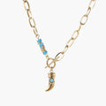 Gold chunky chain necklace with turquoise beaded accent and horn pendant on white background
