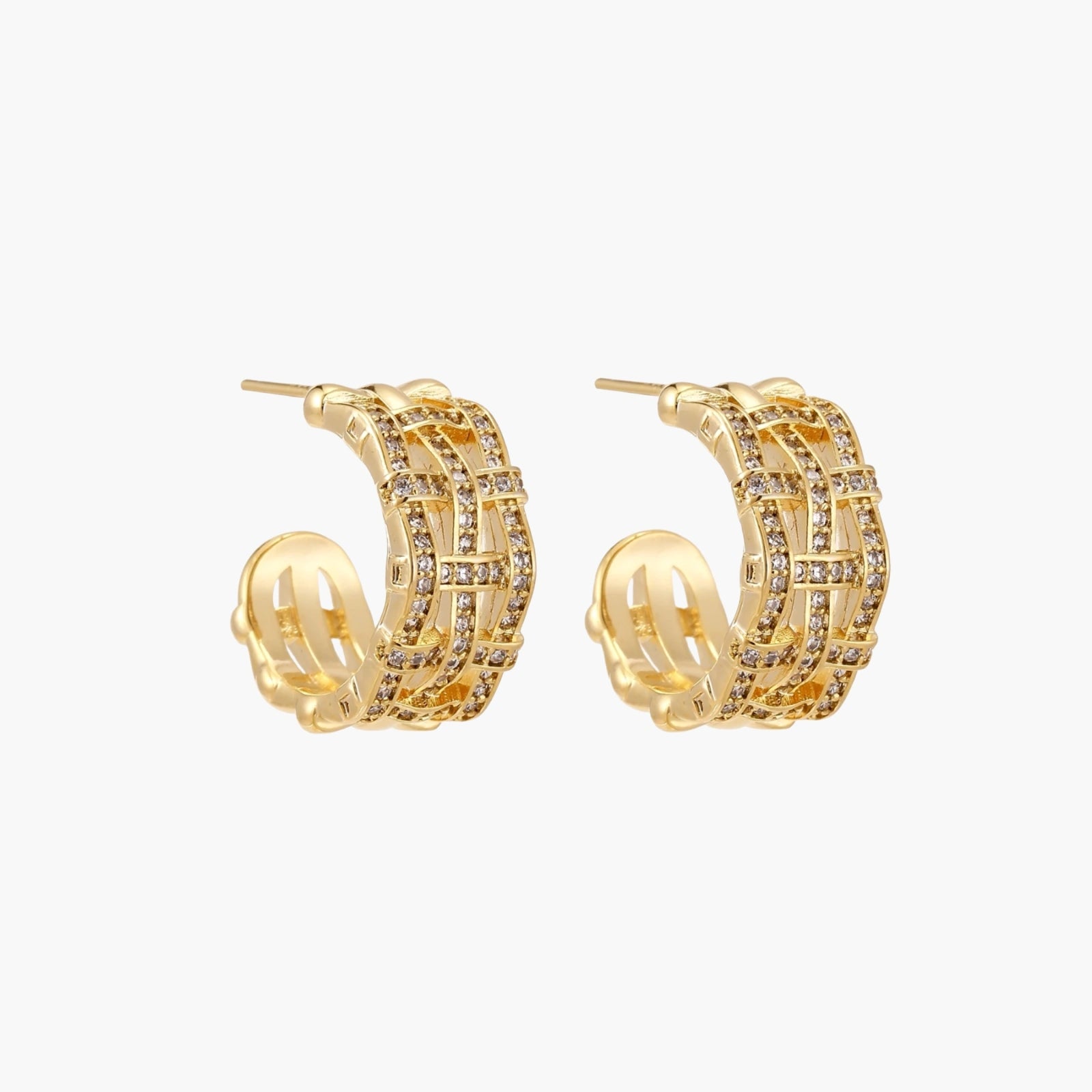 Gold-plated geometric hoop earrings with basket-weave lattice design and pavé crystal accents on cream background