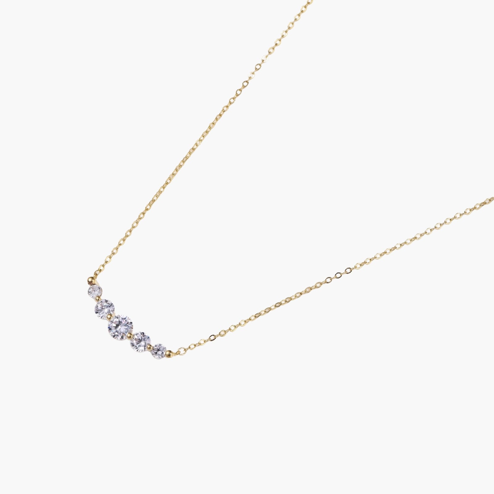 Delicate 14K gold-plated necklace with five graduated zirconia stones arranged in a curved arc on fine chain