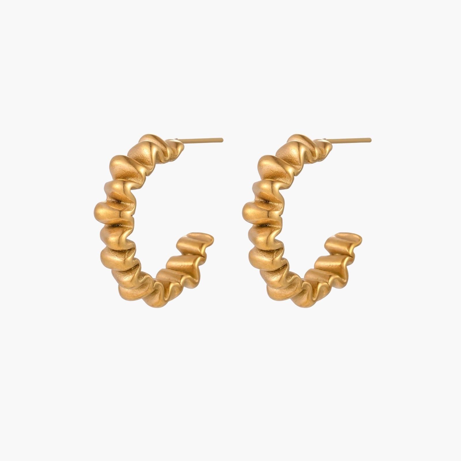 Sculptural gold-plated hoop earrings with continuous twisted spiral design on cream background