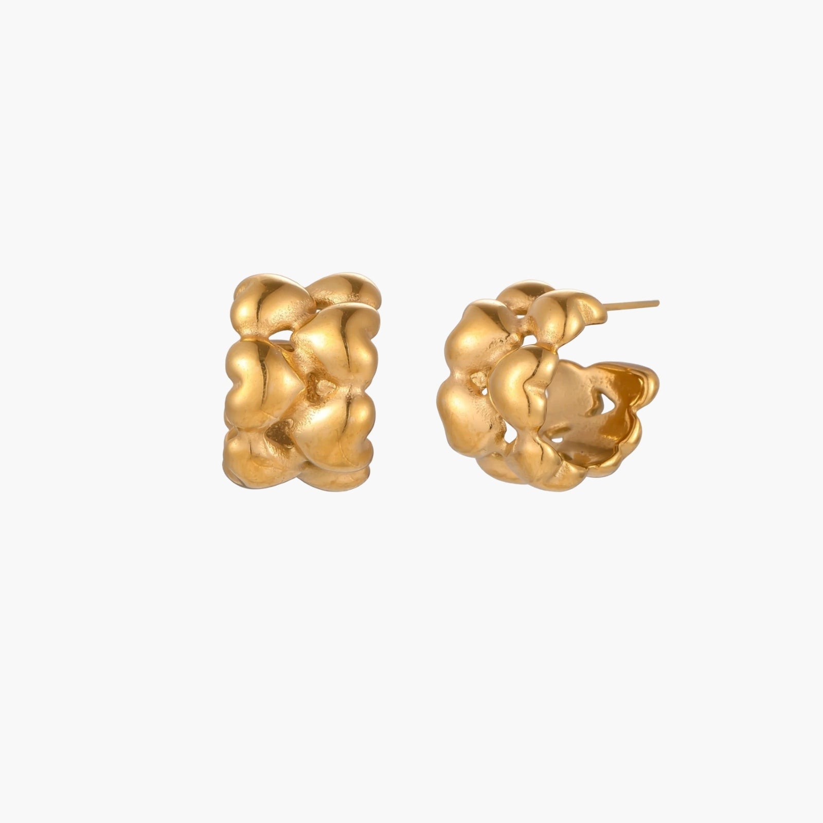 Close-up of gold-plated twisted rope huggie hoop earrings with brushed finish on white background.