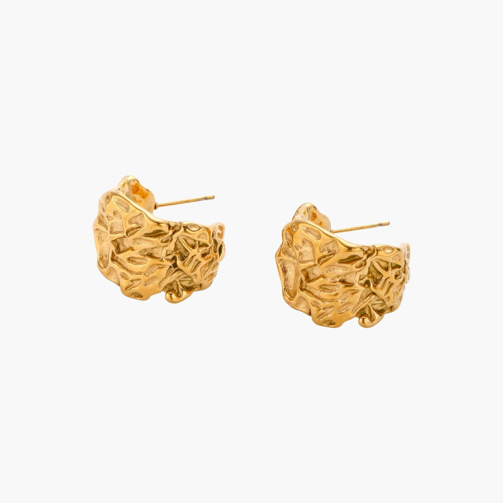 Chunky gold-plated hoop earrings with organic crumpled texture on cream background, 21.5mm sculptural design