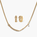 Gold-plated necklace with geometric diamond segments and matching huggie earrings featuring cubic zirconia details